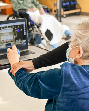 Therapist assisting resident at Fulton Center with RESTORE therapy