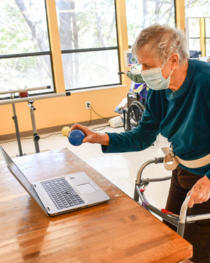 Standing and using RESTORE therapy program at Fulton Center